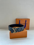 Monogram belt on box, dark patterned strap with gold-tone LV buckle