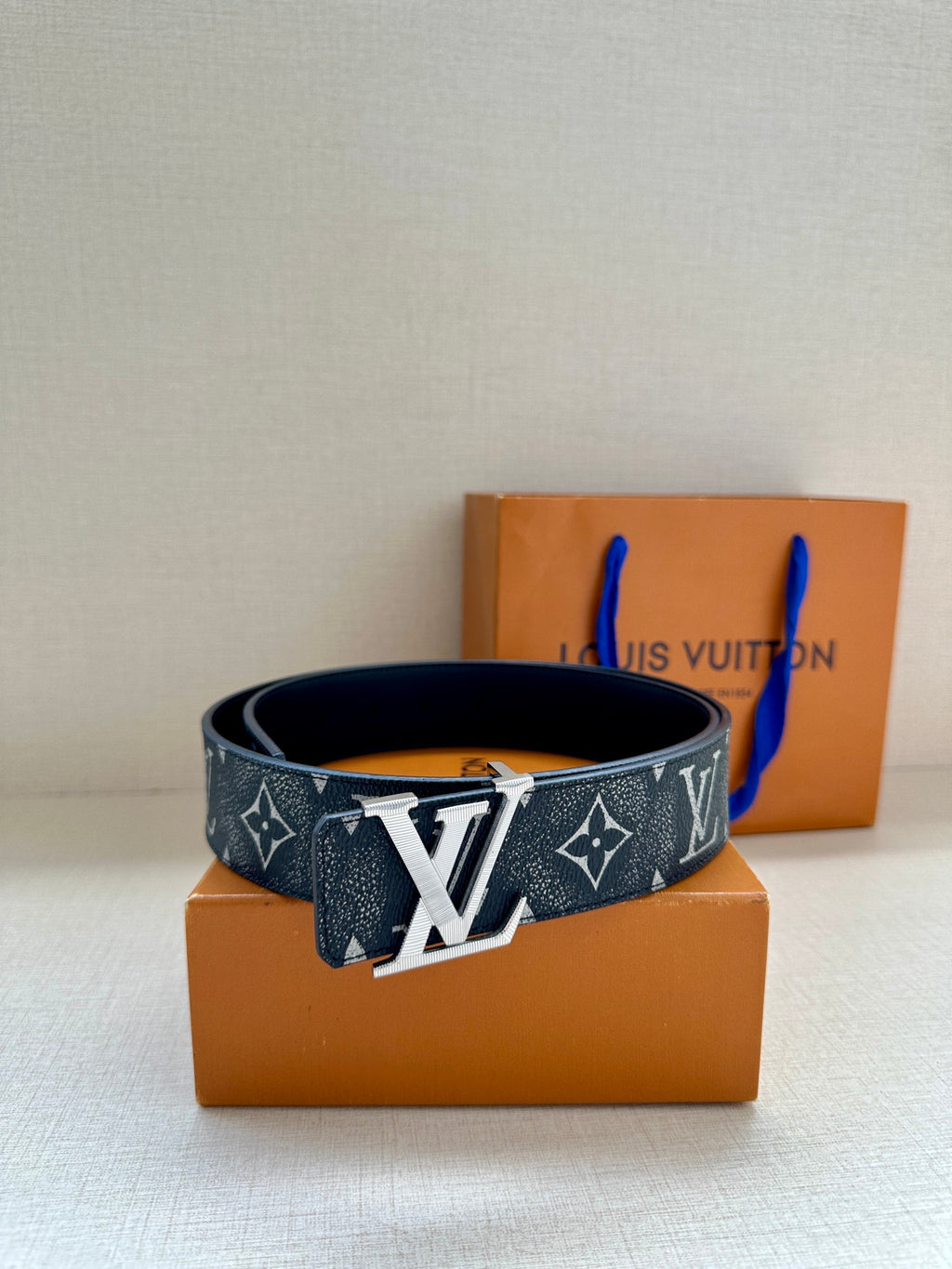 Louis Vuitton monogram belt with dark patterned strap and gold-tone buckle