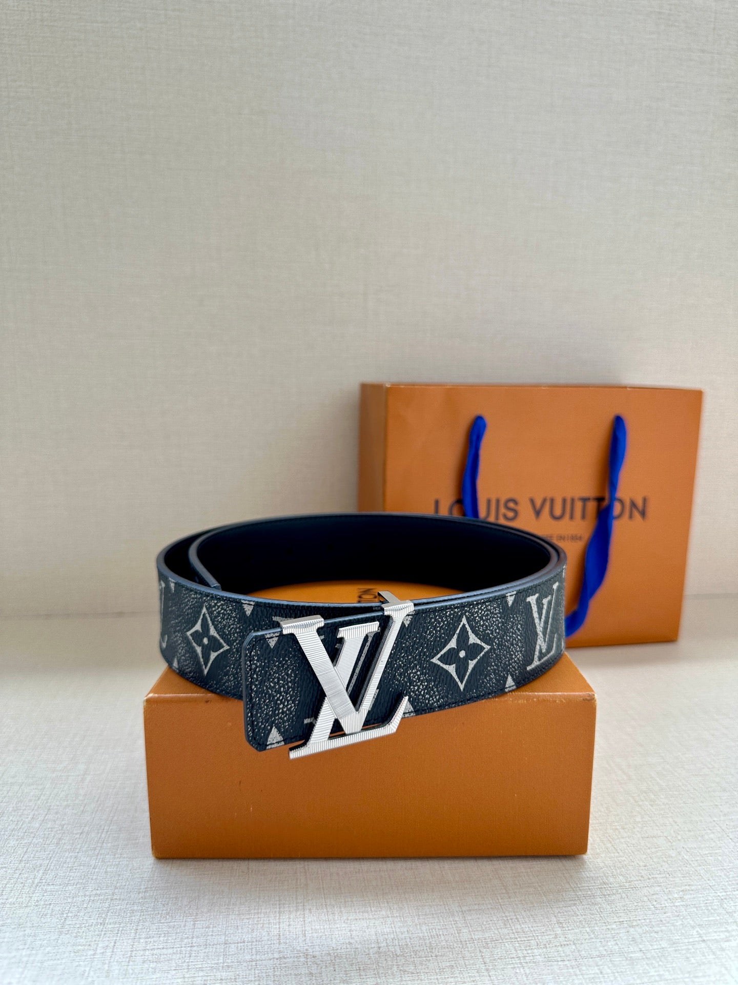 Louis Vuitton monogram belt with dark patterned strap and gold-tone buckle
