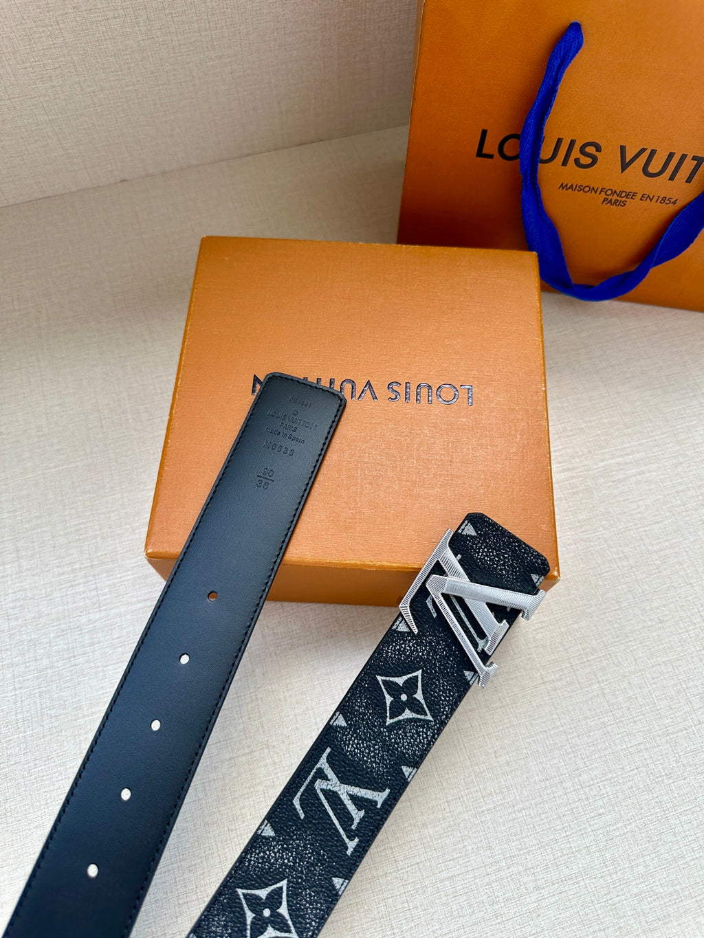 Louis Vuitton belt with dark monogram strap and silver-tone buckle hardware