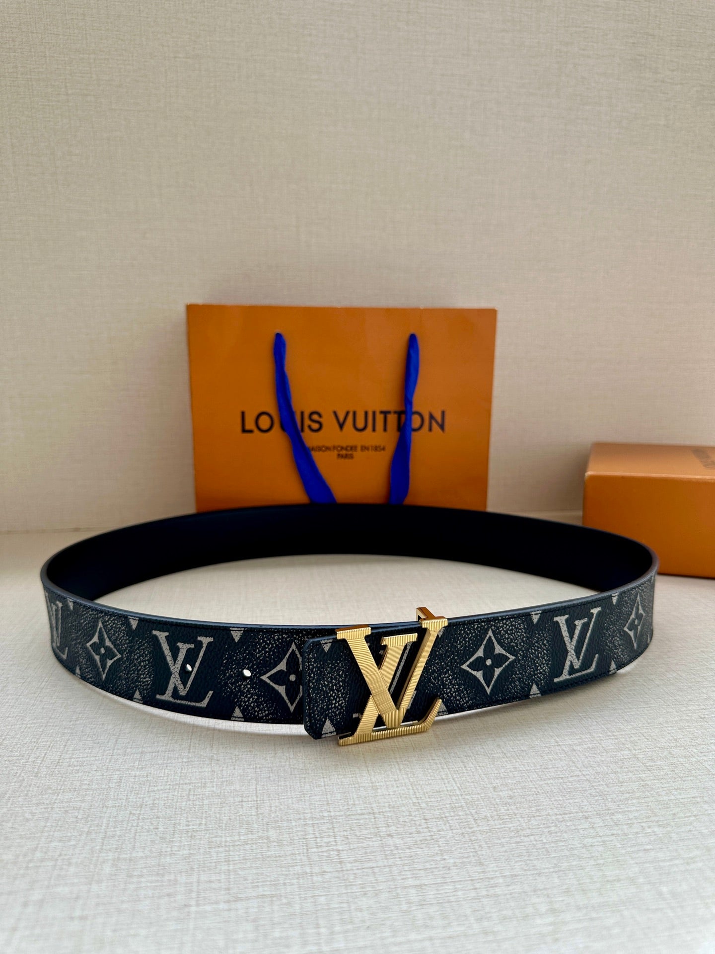 Louis Vuitton monogram belt with dark strap and gold-tone buckle detail