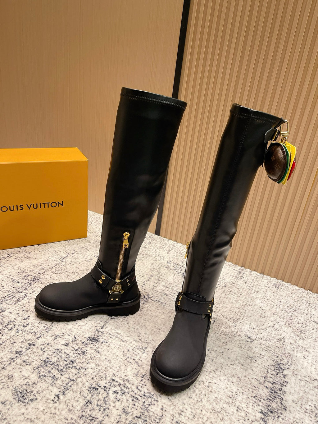 Louis Vuitton unisex black leather knee-high boots, front angle, gold buckle details