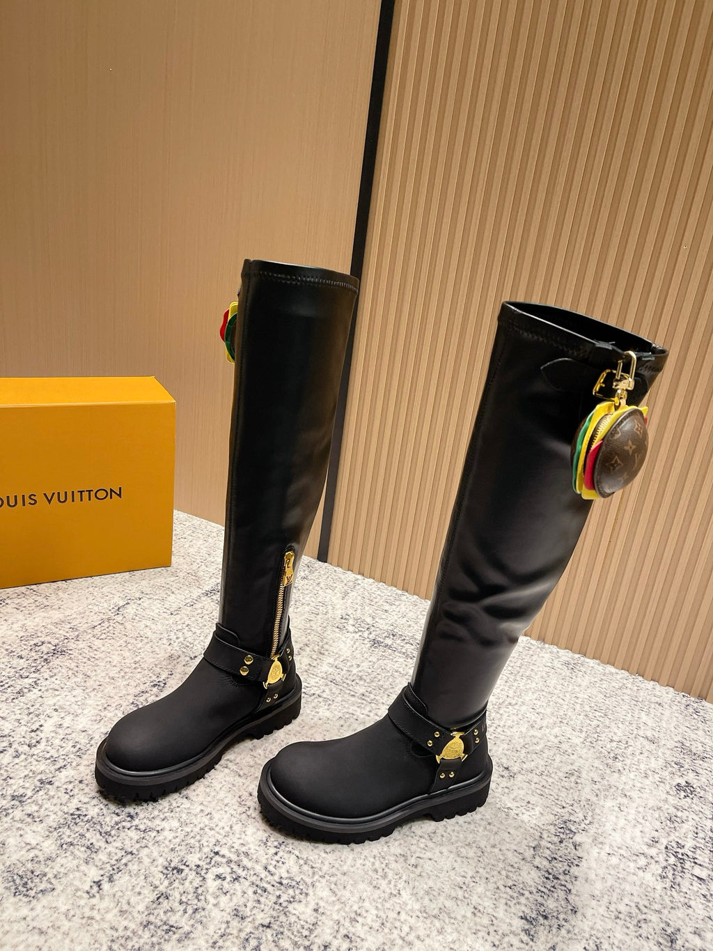 Louis Vuitton unisex black leather knee-high boots, side view, gold hardware and zippers