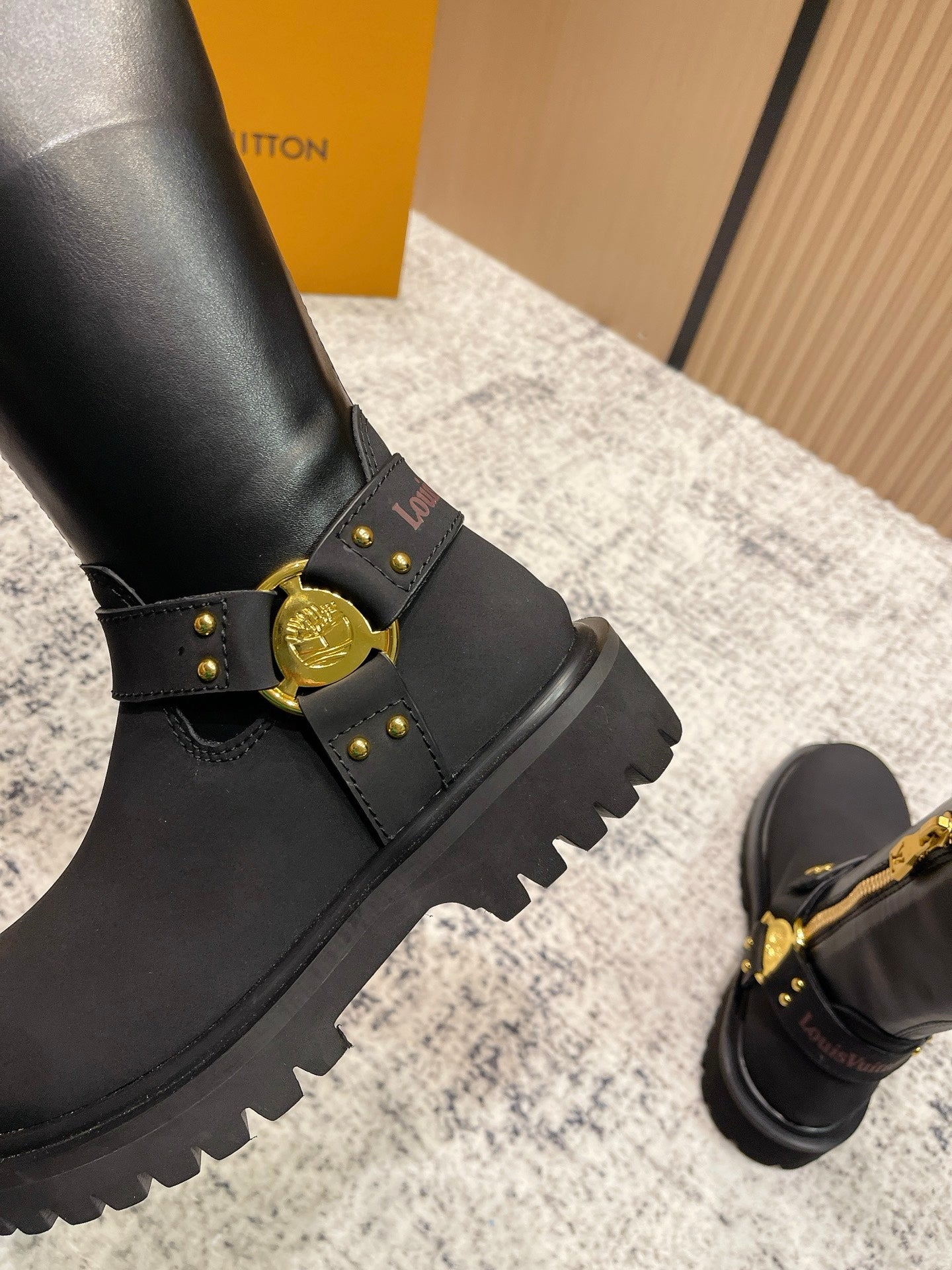 Louis Vuitton unisex black leather boot with gold buckles and serrated platform sole