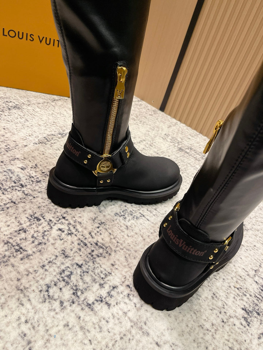 Louis Vuitton unisex black leather knee-high boots with gold zipper pull and buckle hardware