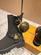 Louis Vuitton black ankle boots with round monogram charm and gold strap hardware, unisex