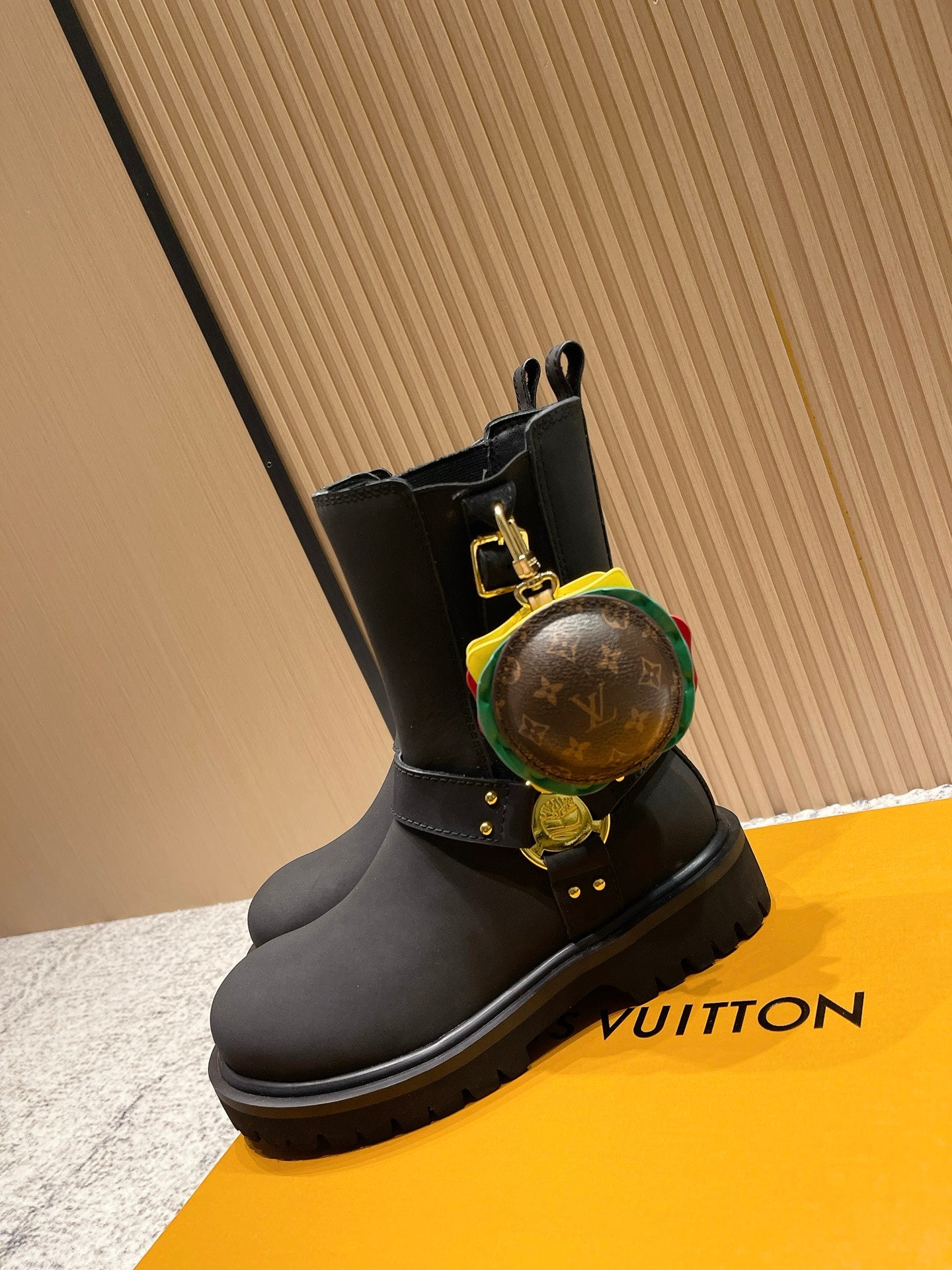 Louis Vuitton black ankle boots with round monogram charm and gold buckles, unisex