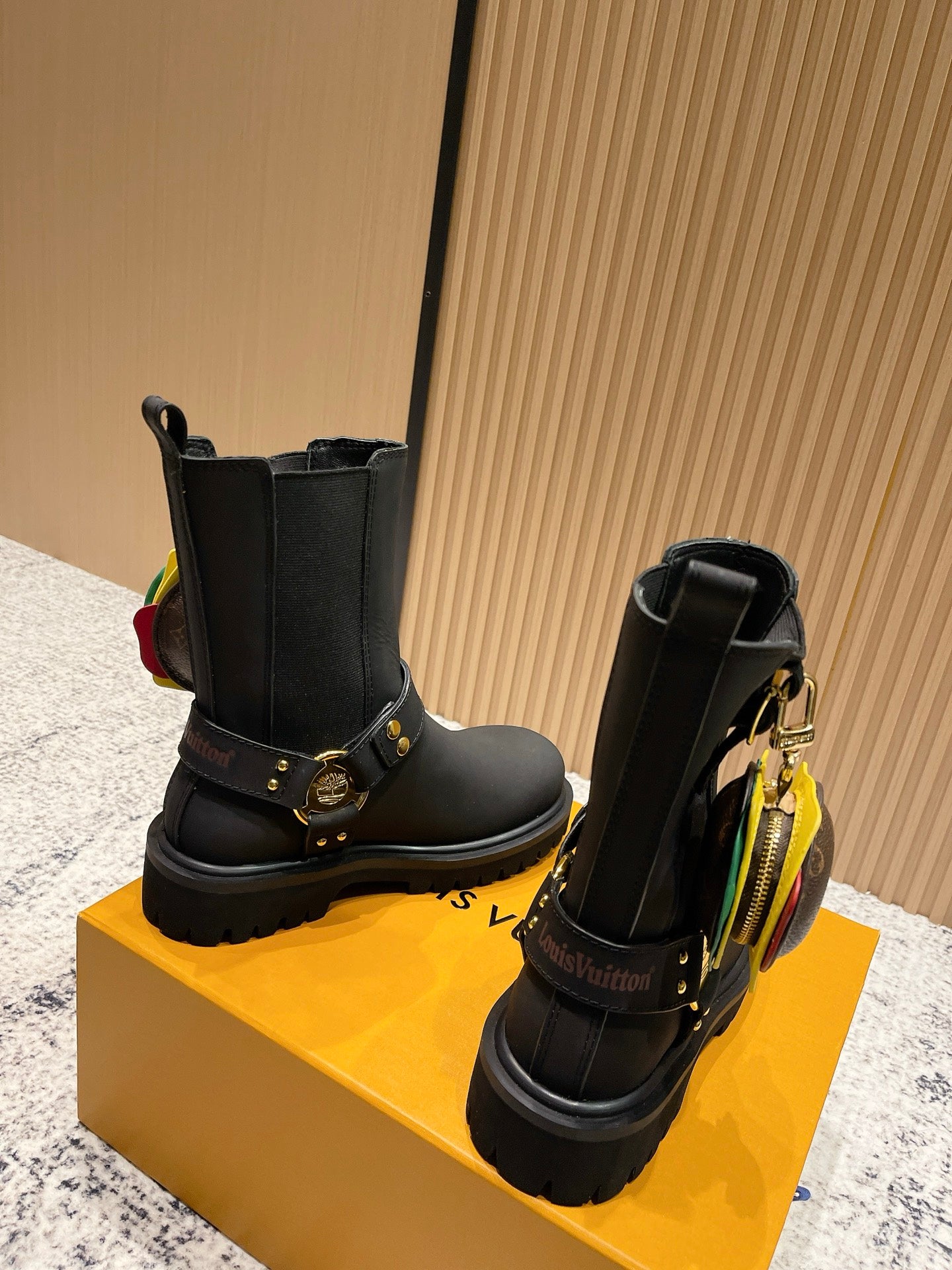 Louis Vuitton black ankle boots with gold side buckles and colorful zipper pull, unisex