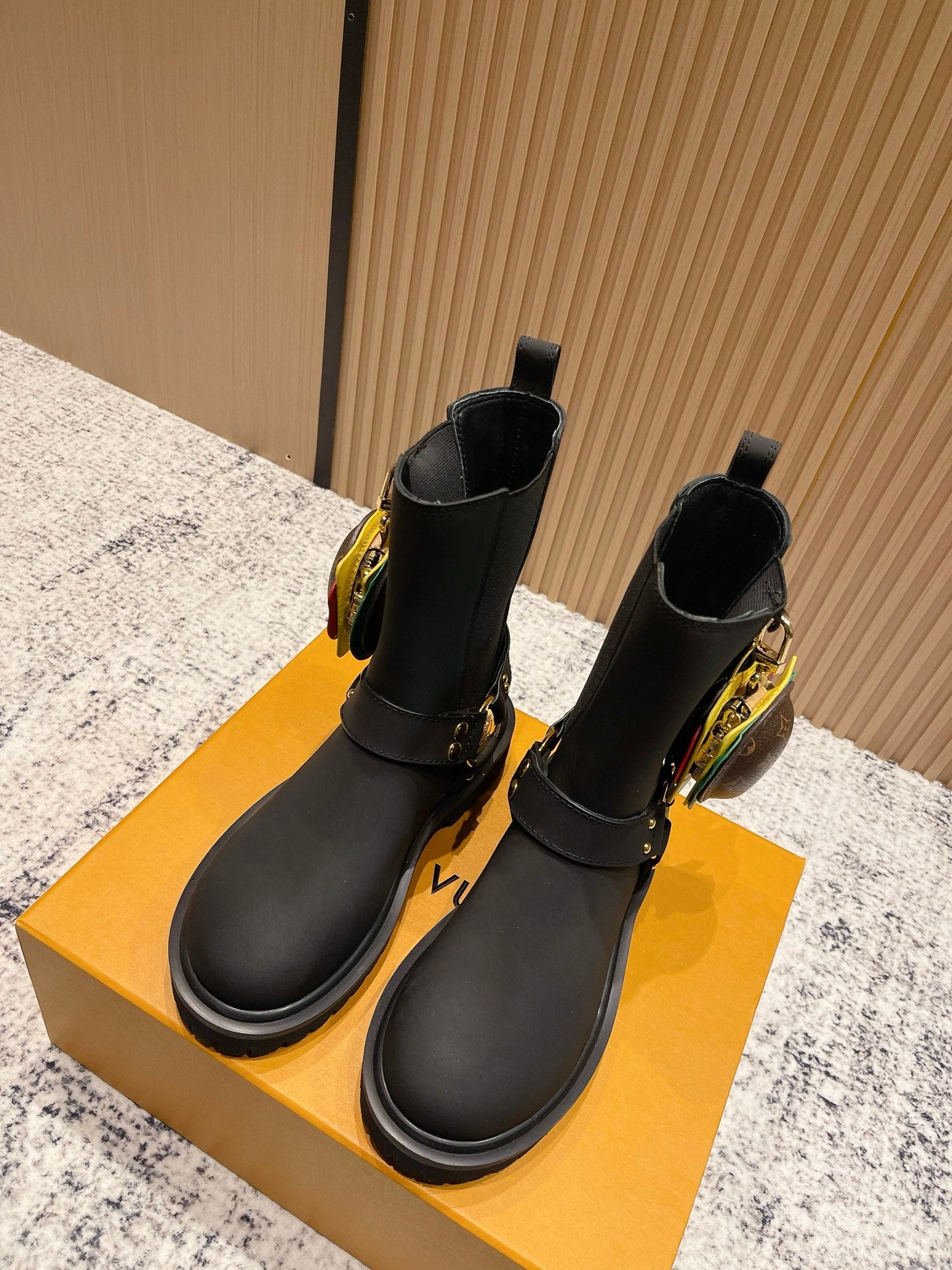 Louis Vuitton black ankle boots with side buckle and gold hardware, unisex