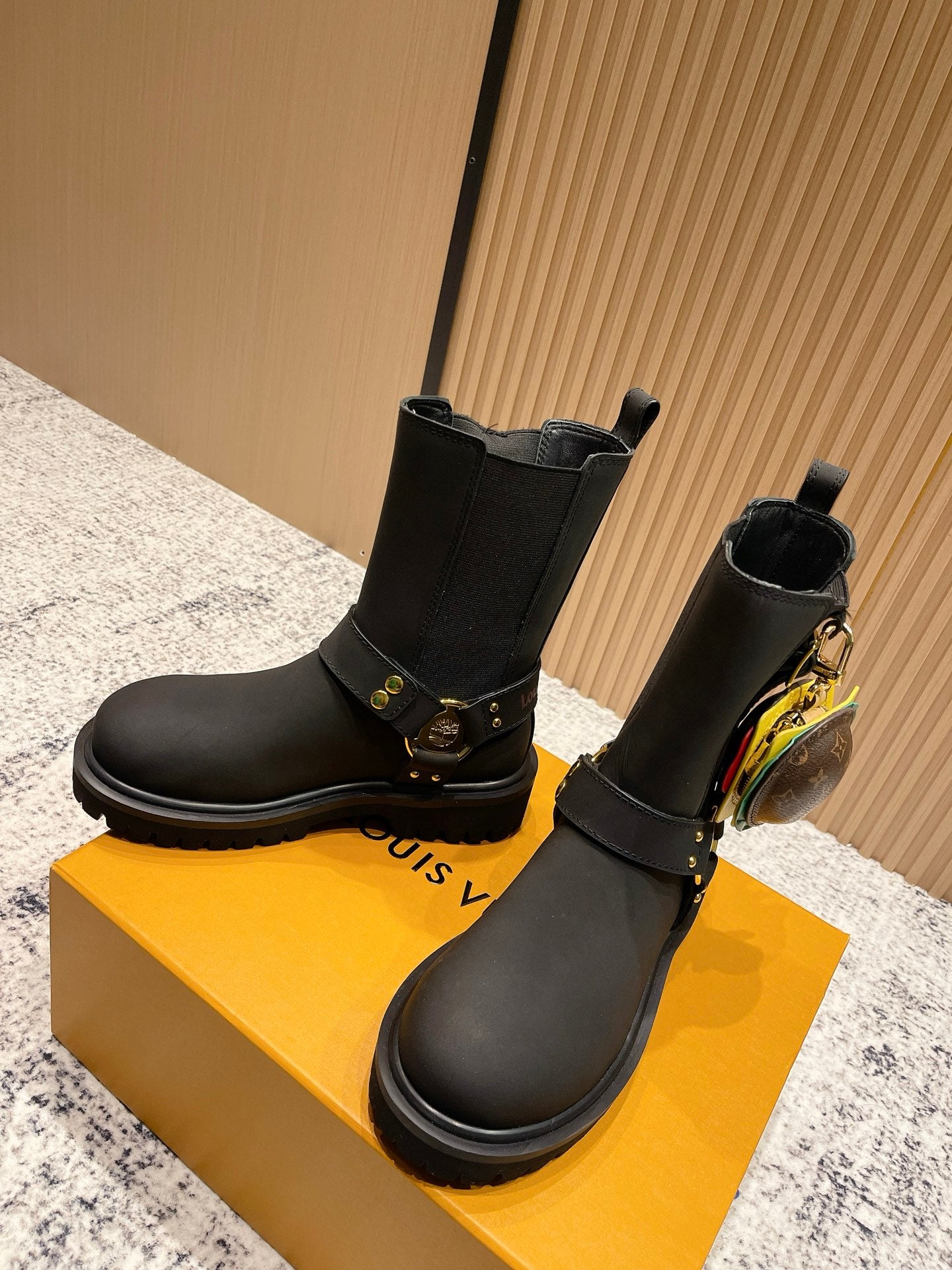 Louis Vuitton black Chelsea-style ankle boots with gold buckle detail, unisex