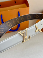White leather belt with dark monogram strap and gold LV-style buckle hardware