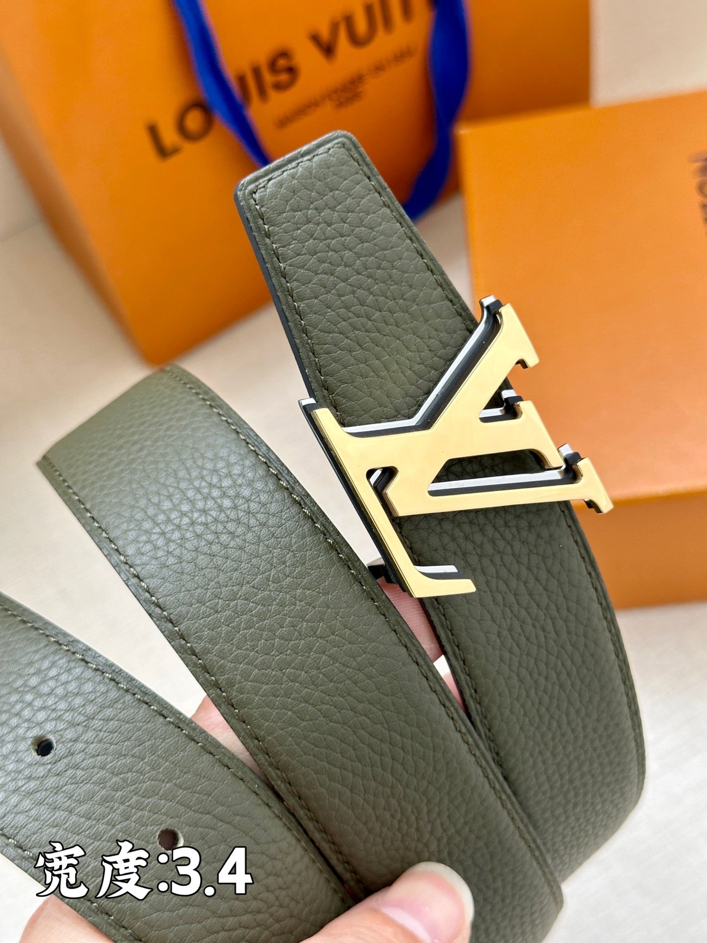 Louis Vuitton belt end with dark green leather, silver buckle hardware and keeper.