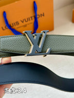 Louis Vuitton belt buckle close-up on dark green leather strap, silver LV logo.