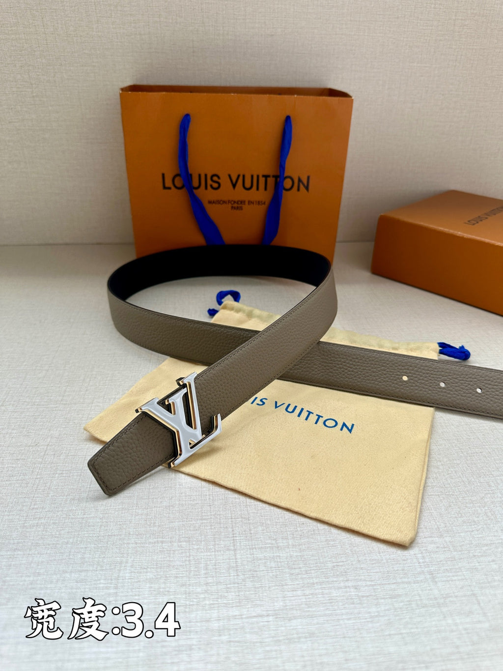 Grey leather belt with gold-tone LV buckle and pin-hole strap