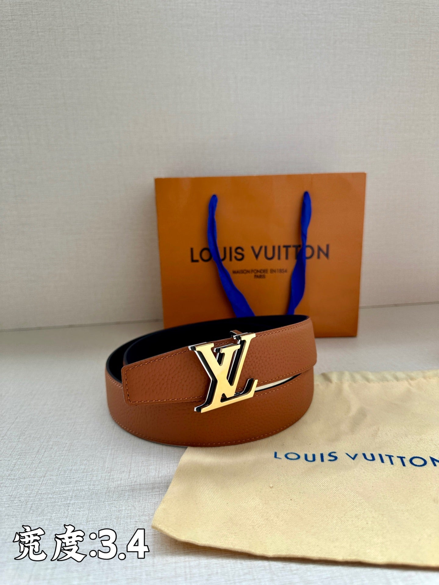 Brown leather belt with gold-tone LV buckle and wide strap