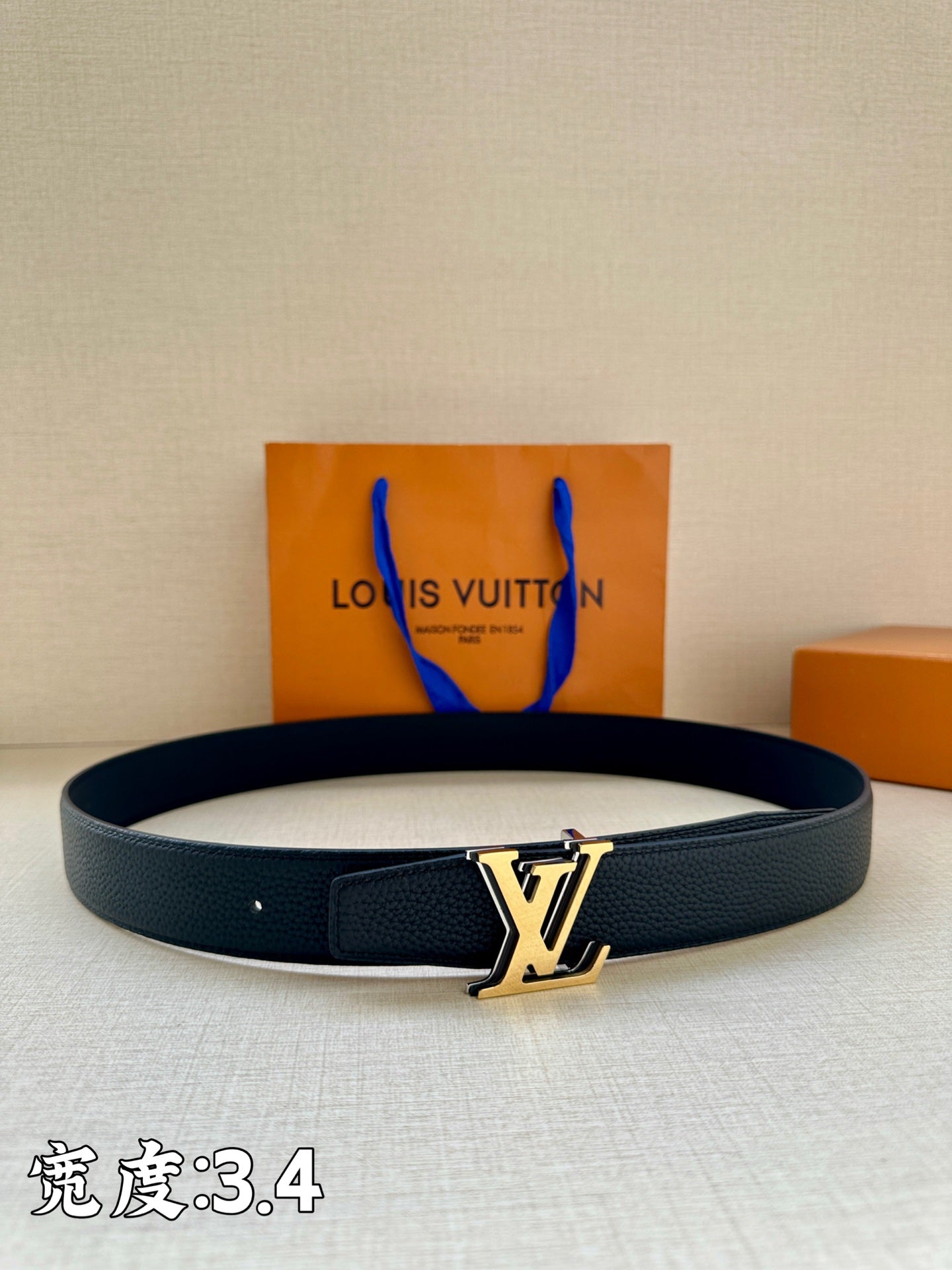 Louis Vuitton leather belt in dark blue with gold LV buckle and keeper