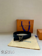 Louis Vuitton leather belt in dark blue with gold LV buckle on a cream dust bag