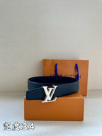 Louis Vuitton dark blue leather belt with gold LV buckle above two boxes