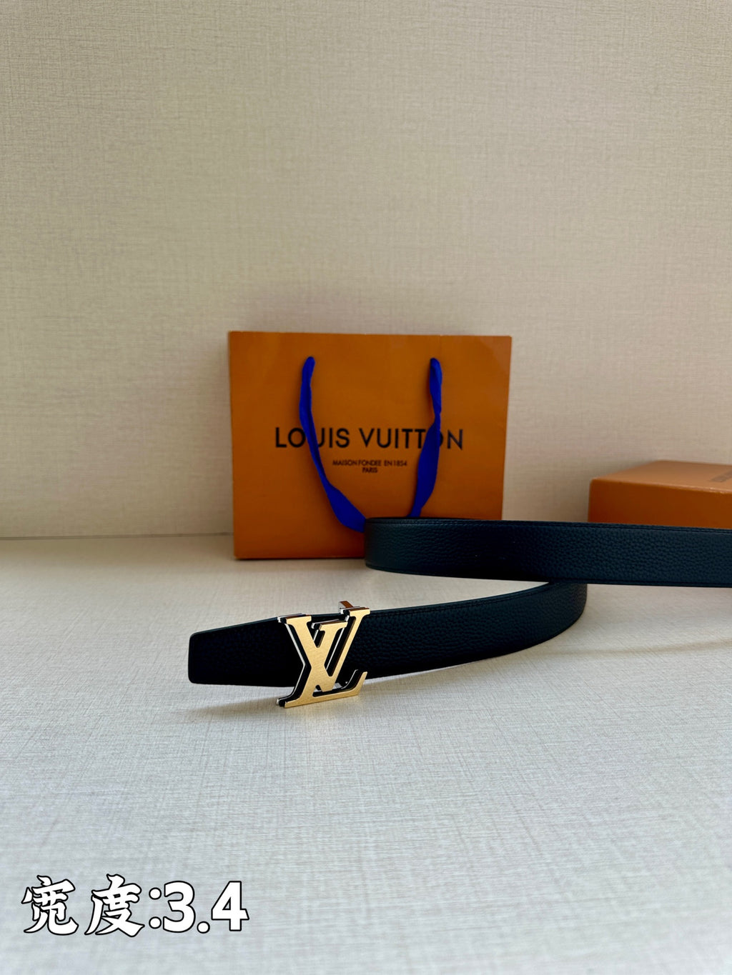 Louis Vuitton dark blue leather belt with gold LV buckle on the strap end
