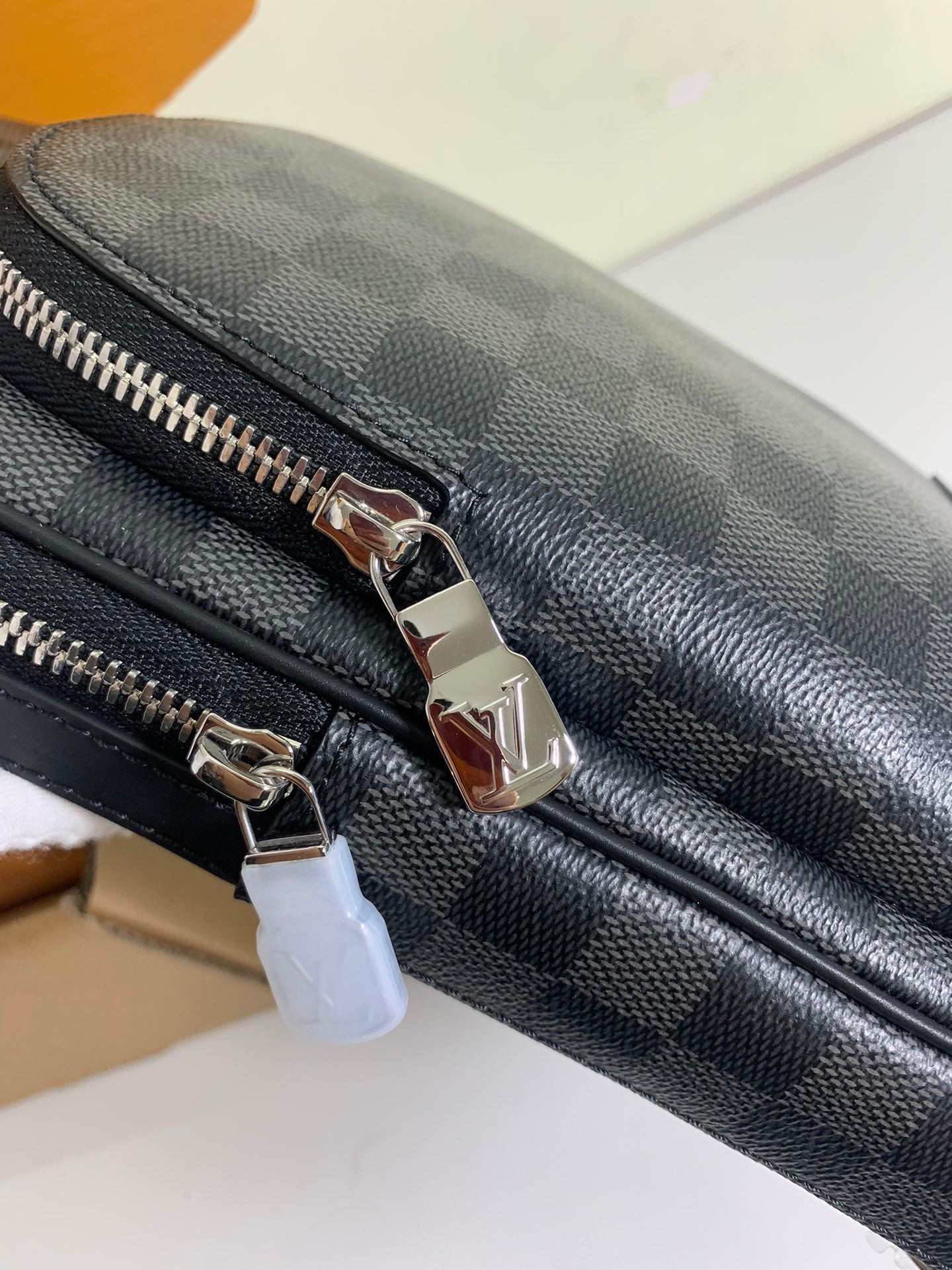 Louis Vuitton damier crossbody bag zipper pull and metal rings on dark trim