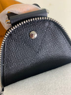 Louis Vuitton bag top zipper and textured finish with small round logo medallion