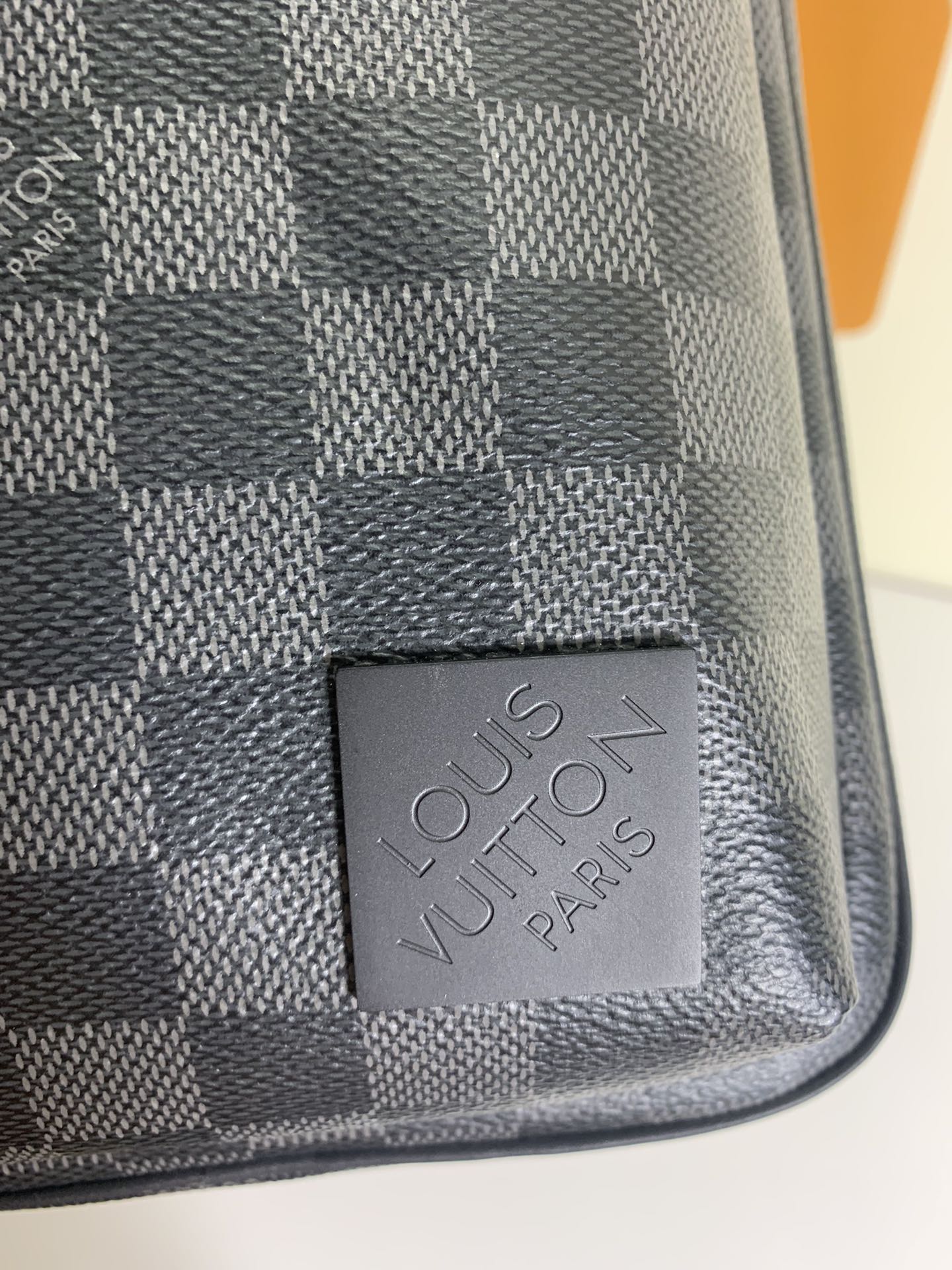 Louis Vuitton Paris leather patch on dark and gray damier-pattern bag