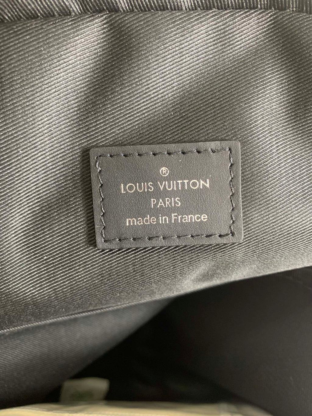 Louis Vuitton interior label reading LOUIS VUITTON PARIS made in France
