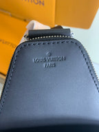 Louis Vuitton logo detail on dark leather trim with zipper top on bag