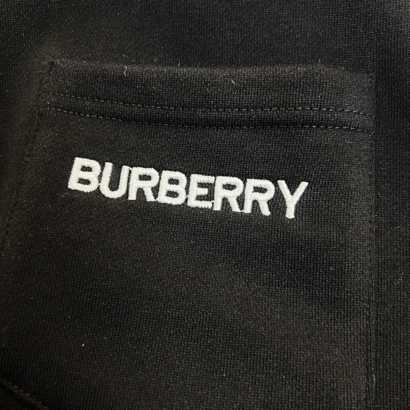 Black Burberry sweatshirt with BURBERRY text logo on fabric
