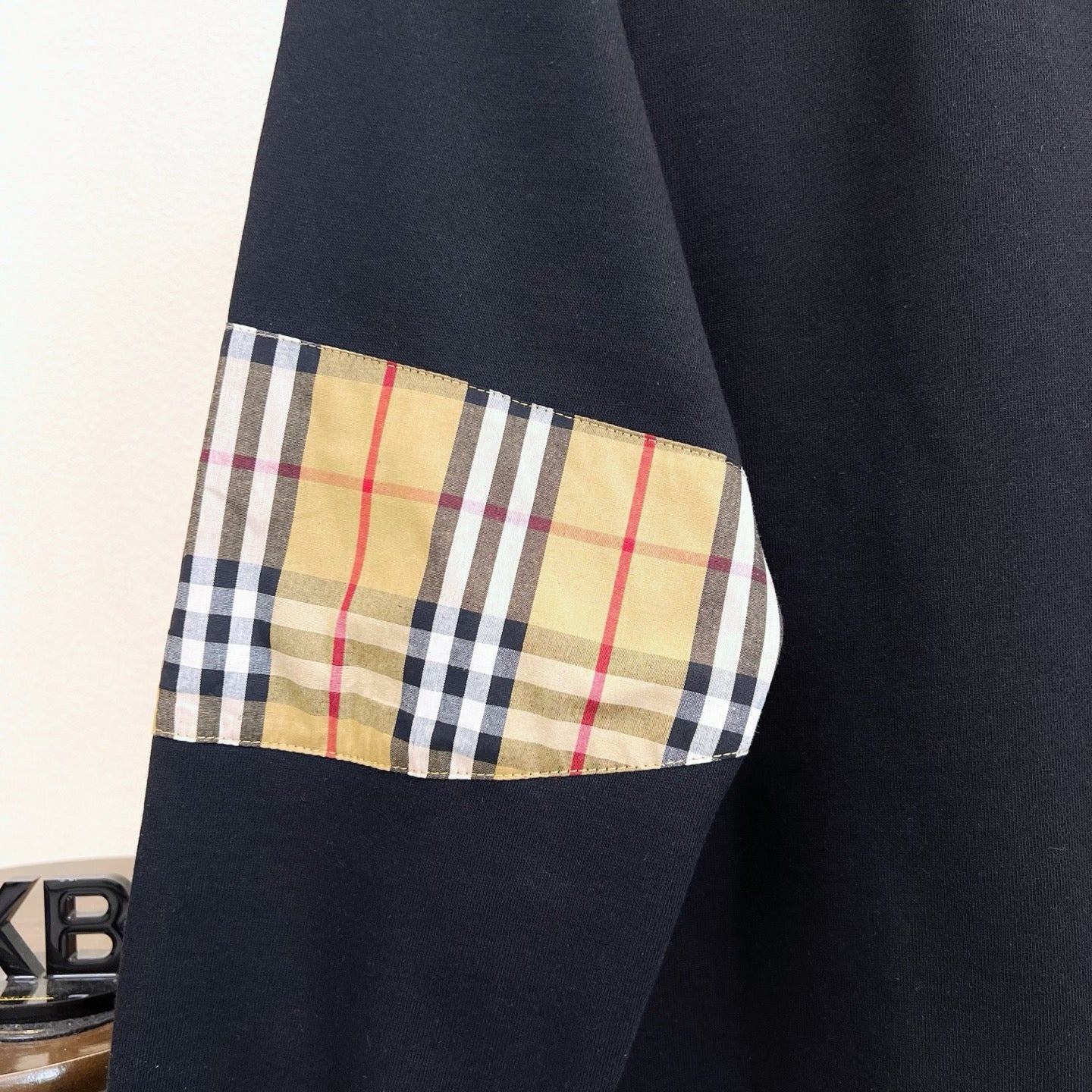Black Burberry sweatshirt with plaid panel detail on sleeve