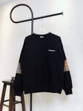 Black Burberry sweatshirt with plaid cuff panels and crew neckline