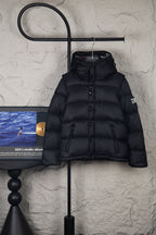 Black puffer jacket with hood and front button placket, quilted panels