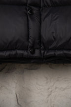 Long puffer coat hem and zipper placket with toggle button, dark fabric
