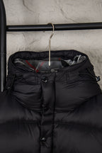 Black puffer jacket hood area with front buttons and quilted inner collar