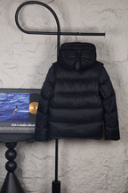 Black hooded puffer jacket with front button placket and quilted bubble stitching