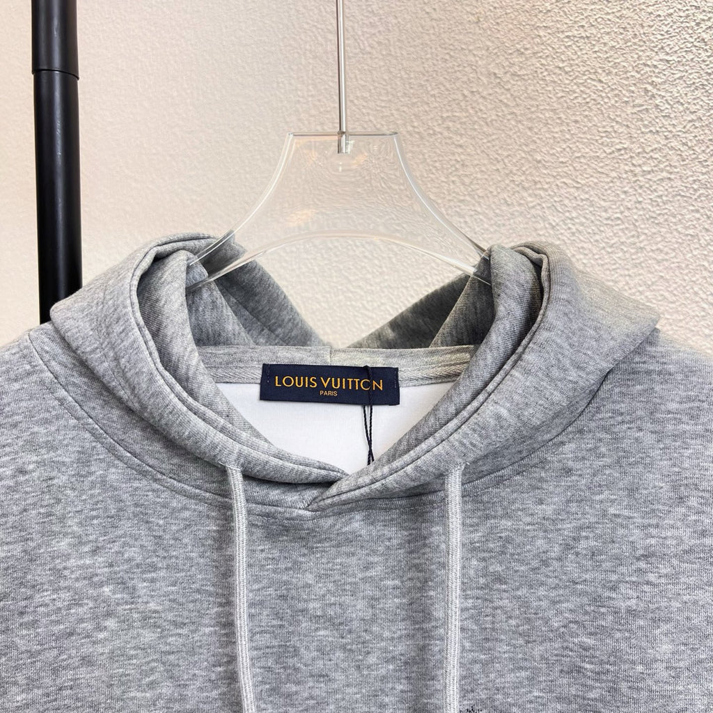 Gray Louis Vuitton hoodie neckline with hood, drawstrings, and logo label.