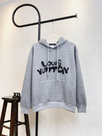 Gray Louis Vuitton hoodie with drawstring hood and large black logo print front.