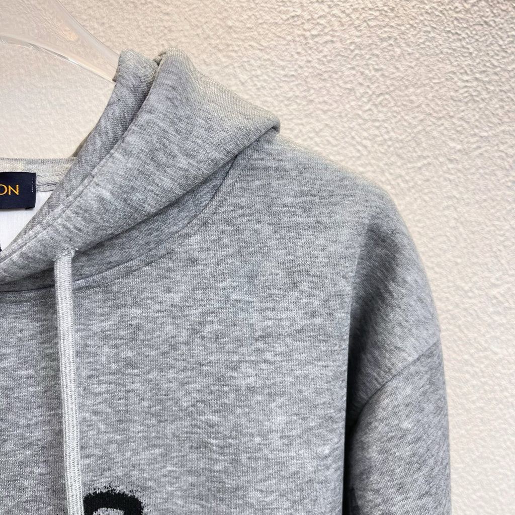 Gray Louis Vuitton hoodie sleeve and shoulder with stitched seam detail.