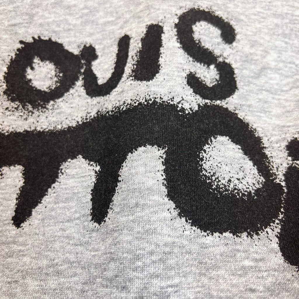 Gray Louis Vuitton hoodie fabric close-up with black stylized logo lettering.