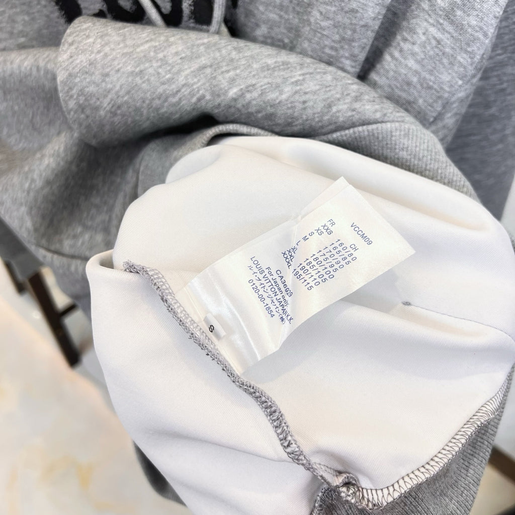 Long graphic shirt collar tag and interior label on light fabric with gray trim