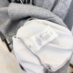 Long graphic shirt collar tag and interior label on light fabric with gray trim