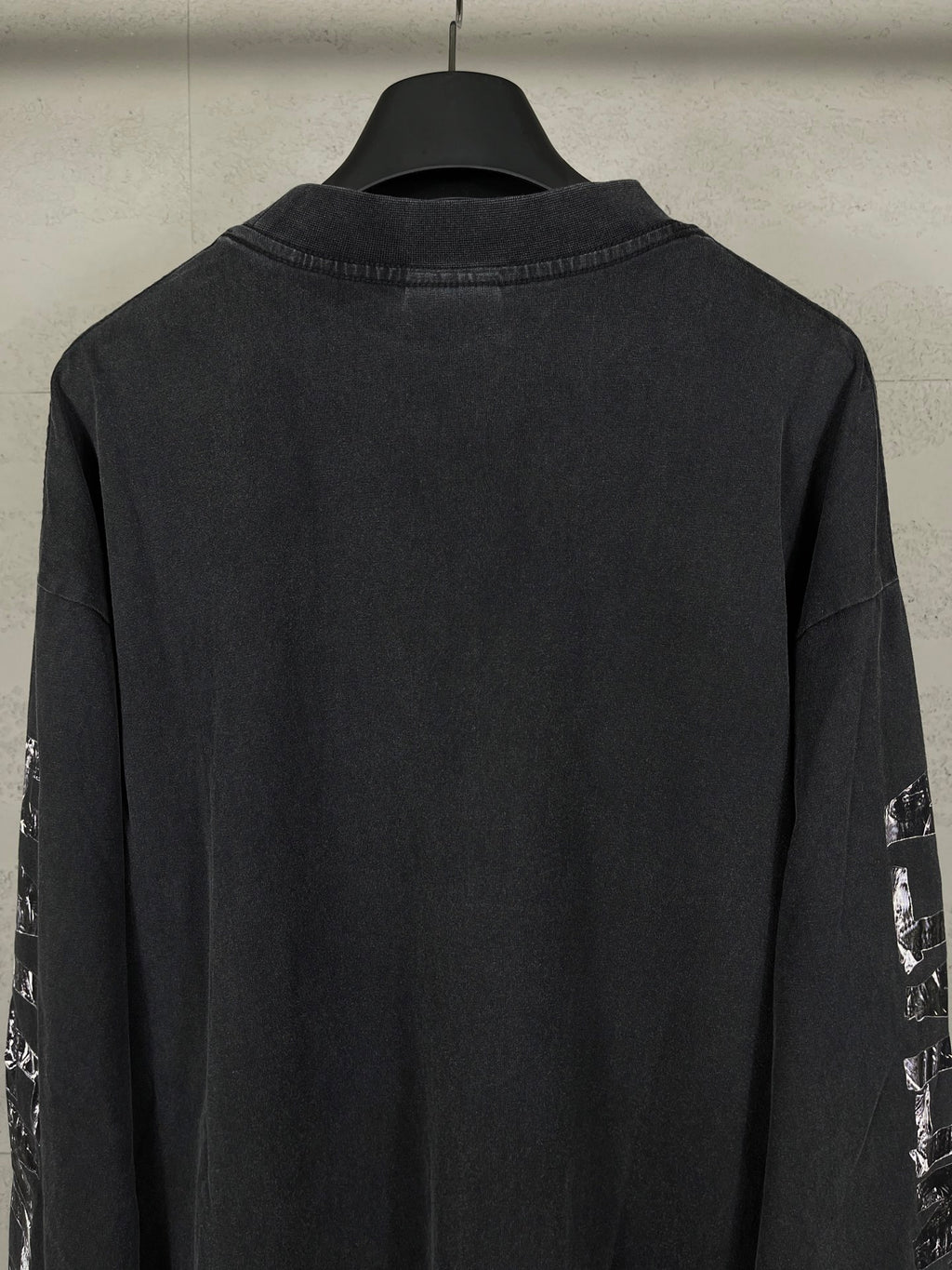 Balenciaga long-sleeve T-shirt back view, dark with printed sleeve logos