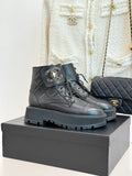 Dark quilted leather lace-up boots with gold chain accents and chunky lug sole