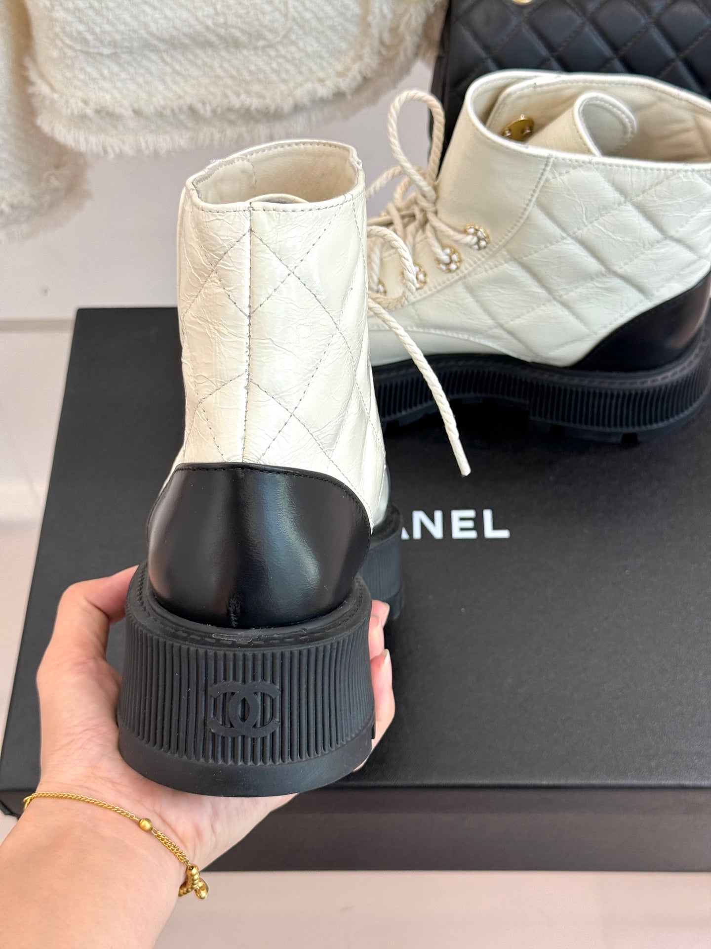 White ankle boots with black heel trim and thick ridged platform sole