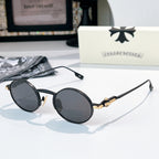 Chrome glasses with black round frames and dark lenses, gold-tone temple hardware detail.