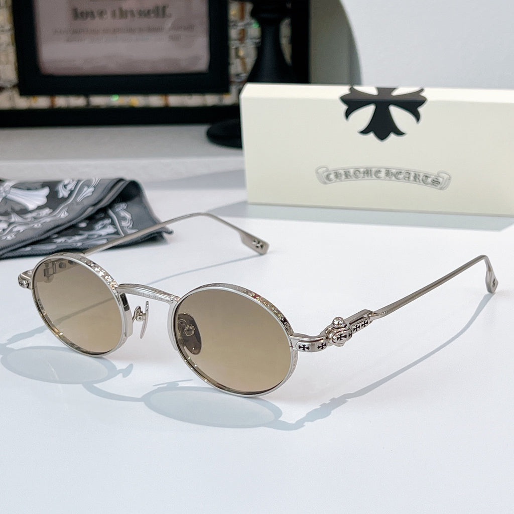 Chrome glasses with silver-tone round frames and light-tint lenses, decorative metal bridge detail.