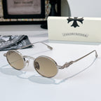 Chrome glasses with silver-tone round frames and light-tint lenses, decorative metal bridge detail.