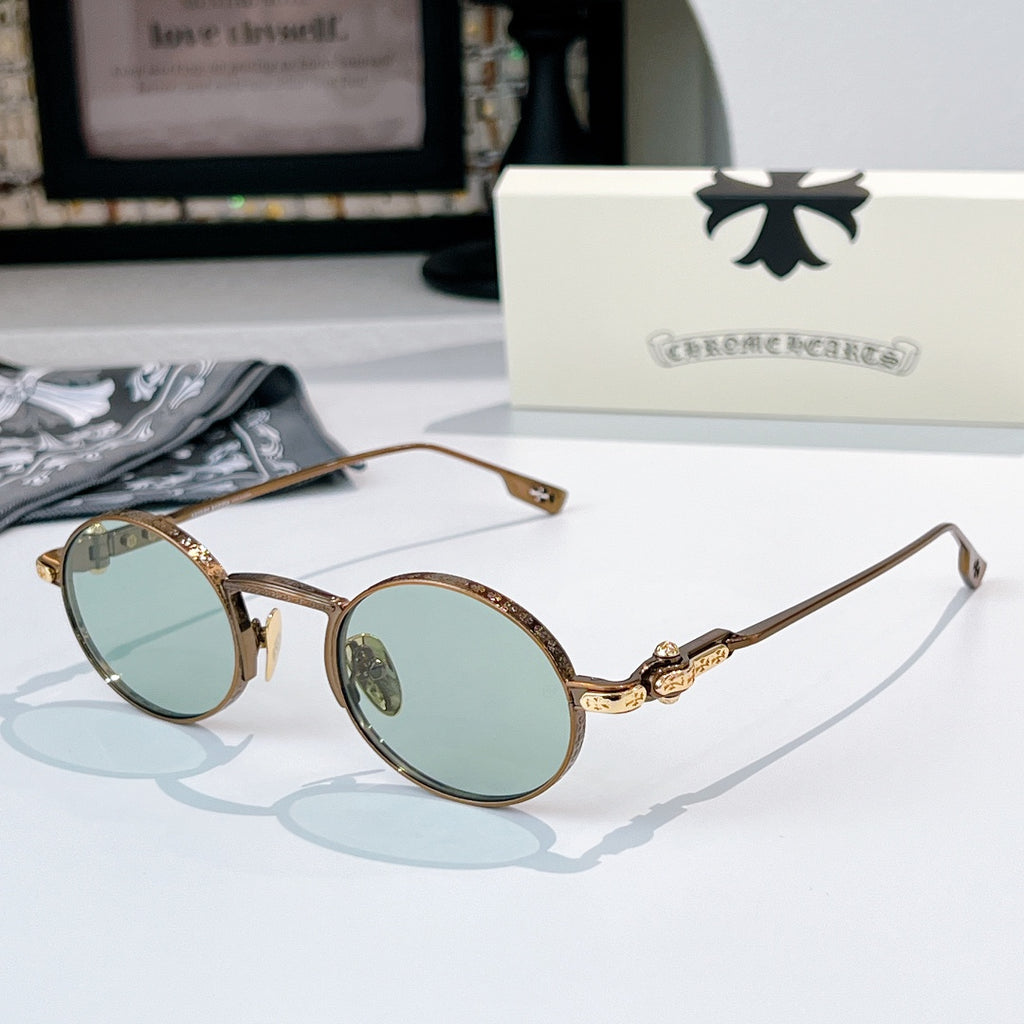 Chrome glasses with brown round frames and light blue-tint lenses, gold-tone metal hinge detail.