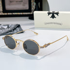 Chrome glasses with gold-tone round frames and dark lenses, metal temples with hinge detail.