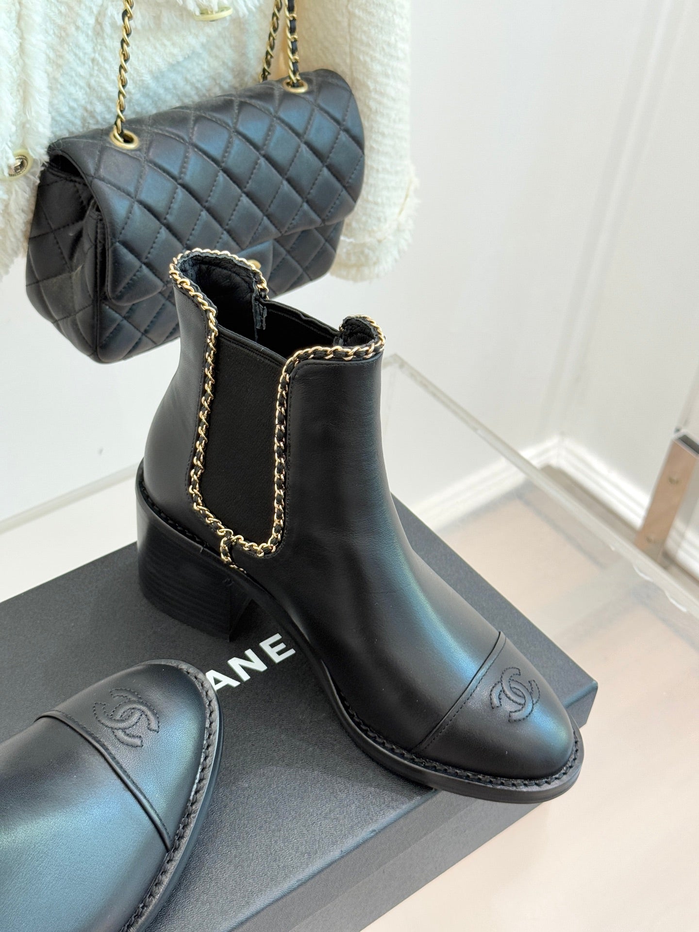 Ladies dark ankle boots with gold chain trim, logo on side, block heel